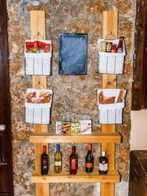 a shelf with bottles of wine and baskets on a wall at Villa Akrolithos with Private Pool in Chania Town