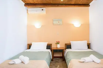 two beds in a room with towels on them at Villa Akrolithos with Private Pool in Chania Town