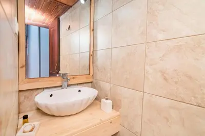 a bathroom with a sink and a mirror at Villa Akrolithos with Private Pool in Chania Town