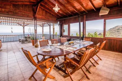 a dining room with a wooden table and chairs at Villa Akrolithos with Private Pool in Chania Town