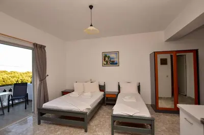 a hospital room with two beds and a window at KOYNTOYRA ROOMS in Kountoura Selino