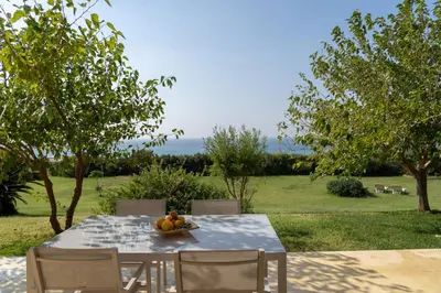 a table with a bowl of fruit on it at Sunset Villas in Falasarna