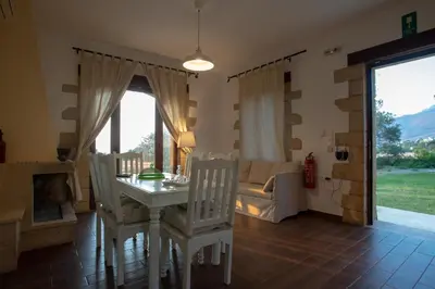 a living room with a table and chairs and a couch at Sunset Villas in Falasarna