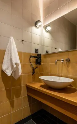 a bathroom with a sink and a mirror at Flâneur in Chania Town