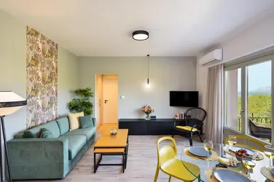 a living room with a couch and a table at Dandelion apartments in Chania Town