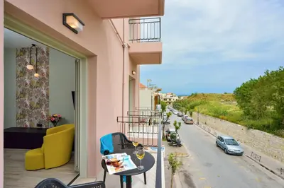 a balcony with a table and a view of a street at Dandelion apartments in Chania Town