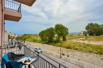 a balcony with a table and a view of a road at Dandelion apartments in Chania Town