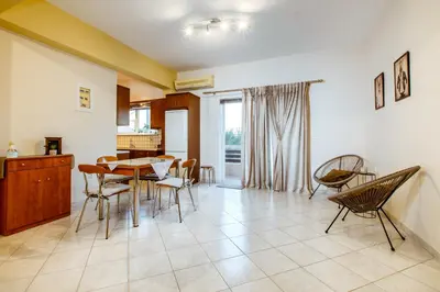 a kitchen and dining room with a table and chairs at Chania Grand Nature Apartment in Chania Town