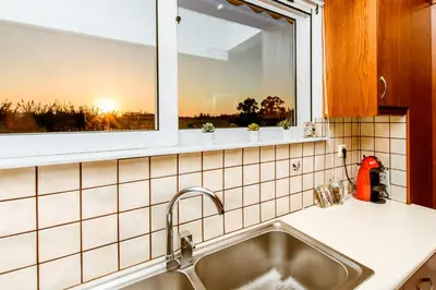 a kitchen with a sink and a window at Chania Grand Nature Apartment in Chania Town