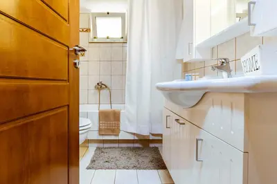 a bathroom with a sink and a toilet at Chania Grand Nature Apartment in Chania Town