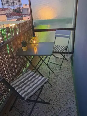 a table and two chairs on a balcony at C-Home Studio in the heart of Chania in Chania Town