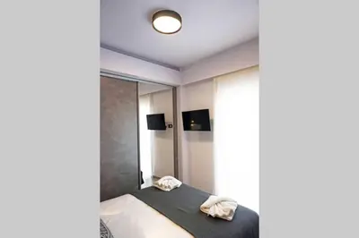 a bedroom with a bed and a large window at C-Home Studio in the heart of Chania in Chania Town