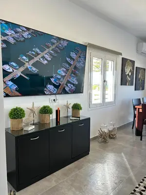 a room with a large painting of boats on the wall at Mira Sea View Residence in Chania Town