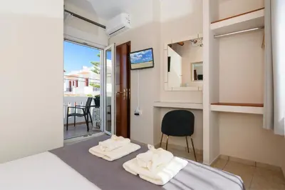 a room with two towels on a bed with a view at Marianthi's Maisonette in Chania Town