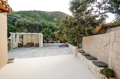 a patio with a fence and trees and a building at Apartment close to Balos-Elafonisi and Falasarna! in Kámbos