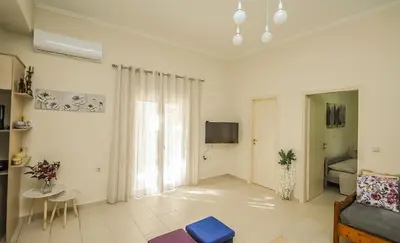 a living room with a couch and a tv at Apartment close to Balos-Elafonisi and Falasarna! in Kámbos
