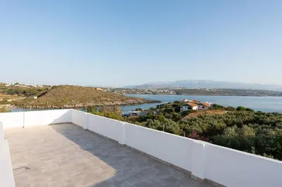 a balcony of a house with a view of the water at Villa Kiara 2 in Tersanas