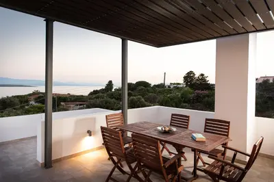 a dining room with a table and chairs at Villa Kiara 2 in Tersanas