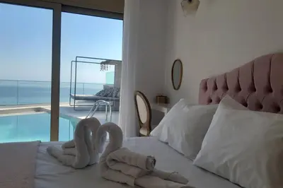 two swans made out of towels sitting on a bed at Luxury Villa Dioskouroi Heated eco pool & jacuzzi in Kalyves