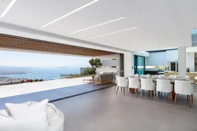 an open living room with a view of the ocean at Cavo Dago in Chania Town