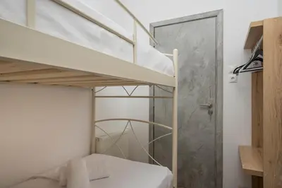 a small bedroom with a bunk bed and a shower at Villa Alitocatos in Drapaniás