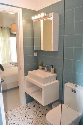 a bathroom with a sink and a toilet and a mirror at Leonidas House in Chania Town