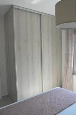 a bedroom with a wall of wooden panels at Leonidas House in Chania Town