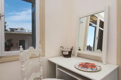 a mirror and a plate on a table in front of a window at Dominic Chania 2 Room Apartment in Chania Town