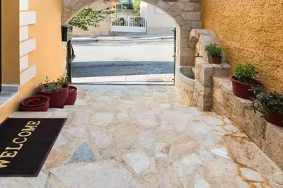 an entrance to a building with potted plants on the sidewalk at Dominic Chania 2 Room Apartment in Chania Town