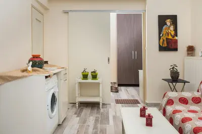 a living room with a washer and dryer at Dominic Chania 2 Room Apartment in Chania Town