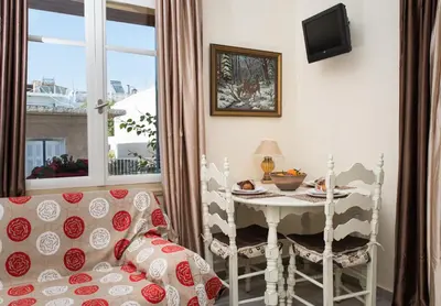a living room with a table and a chair at Dominic Chania 2 Room Apartment in Chania Town