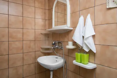 a bathroom with a sink and a mirror at Dominic Chania 2 Room Apartment in Chania Town