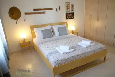 a bedroom with a bed with two towels on it at Bellisima Campagna Home pelekapina -chania crete in Chania Town