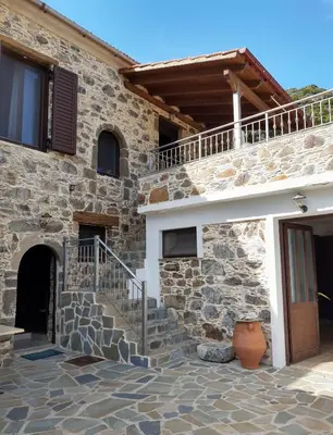 a stone house with stairs and a balcony at Grandma Agatha & Virginia's stonehouse in Kefálion