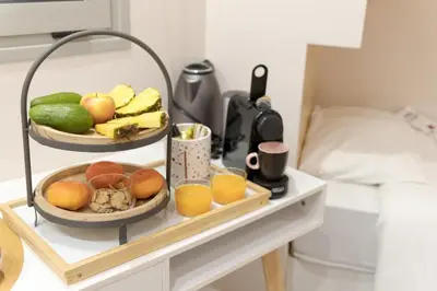 a table with two bowls of fruit and drinks on it at Mitos Cozy Rooms in Chania Town