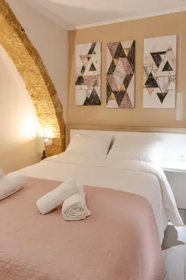 a bedroom with a bed with a towel on it at Mitos Cozy Rooms in Chania Town