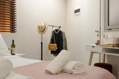 a bedroom with a bed with a towel on a table at Mitos Cozy Rooms in Chania Town