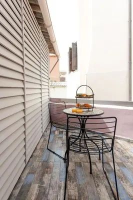 a table and two chairs on a patio at Mitos Cozy Rooms in Chania Town