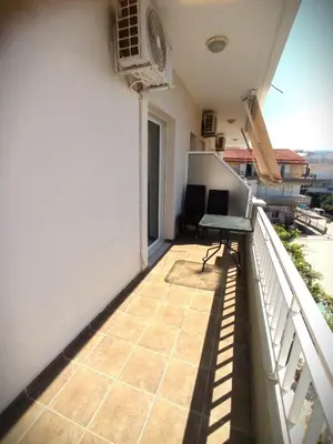 a balcony with a desk on the side of a building at Tasos Seagull apartments in Chania Town