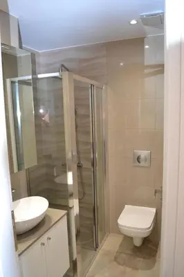 a bathroom with a toilet and a sink and a shower at Filia Luxury Apartment in Chania Town