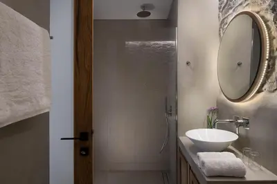 a bathroom with a sink and a mirror at The Authentic Village Boutique Hotel in Khóra Sfakíon