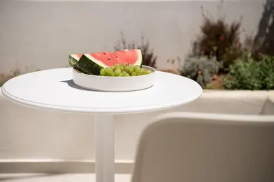 a bowl of watermelon and grapes on a table at The Authentic Village Boutique Hotel in Khóra Sfakíon