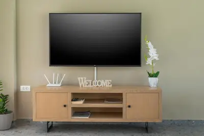 a television on top of a wooden entertainment center at Ethereal Villas Chania in Daratso