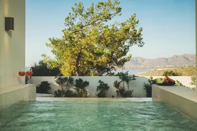 a pool in a house with a view of the water at Lux sea view villa by Chania LIving Stories in Chania Town