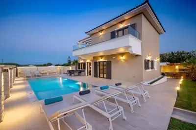 a villa with a swimming pool and a house at Villa Persephone in Tavronitis