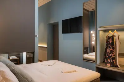 a bedroom with a bed and a mirror at Veneri Boutique Suites in Chania Town