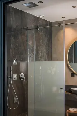 a shower with a glass door in a bathroom at Veneri Boutique Suites in Chania Town