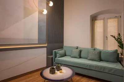 a living room with a green couch and a table at Veneri Boutique Suites in Chania Town