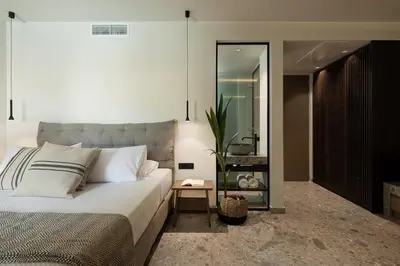 a bedroom with a large bed and a mirror at Casa Nostos in Agia Marina Nea Kydonias
