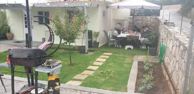 a garden with two people sitting at a table at γαληνη in Vamos